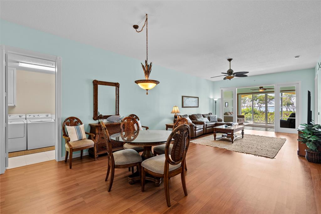 23 Harbour Isle Drive West, Unit 102 Fort Pierce, FL 34949 - Photo 10 of 40 a view of a dining room and livingroom with furniture wooden floor a rug