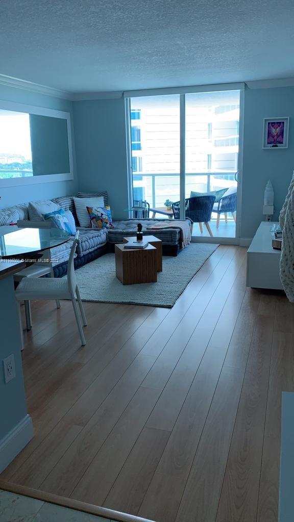 2101 Brickell Avenue, Unit 1709 Miami, FL 33129 - Photo 14 of 14 a living room with furniture and a large window