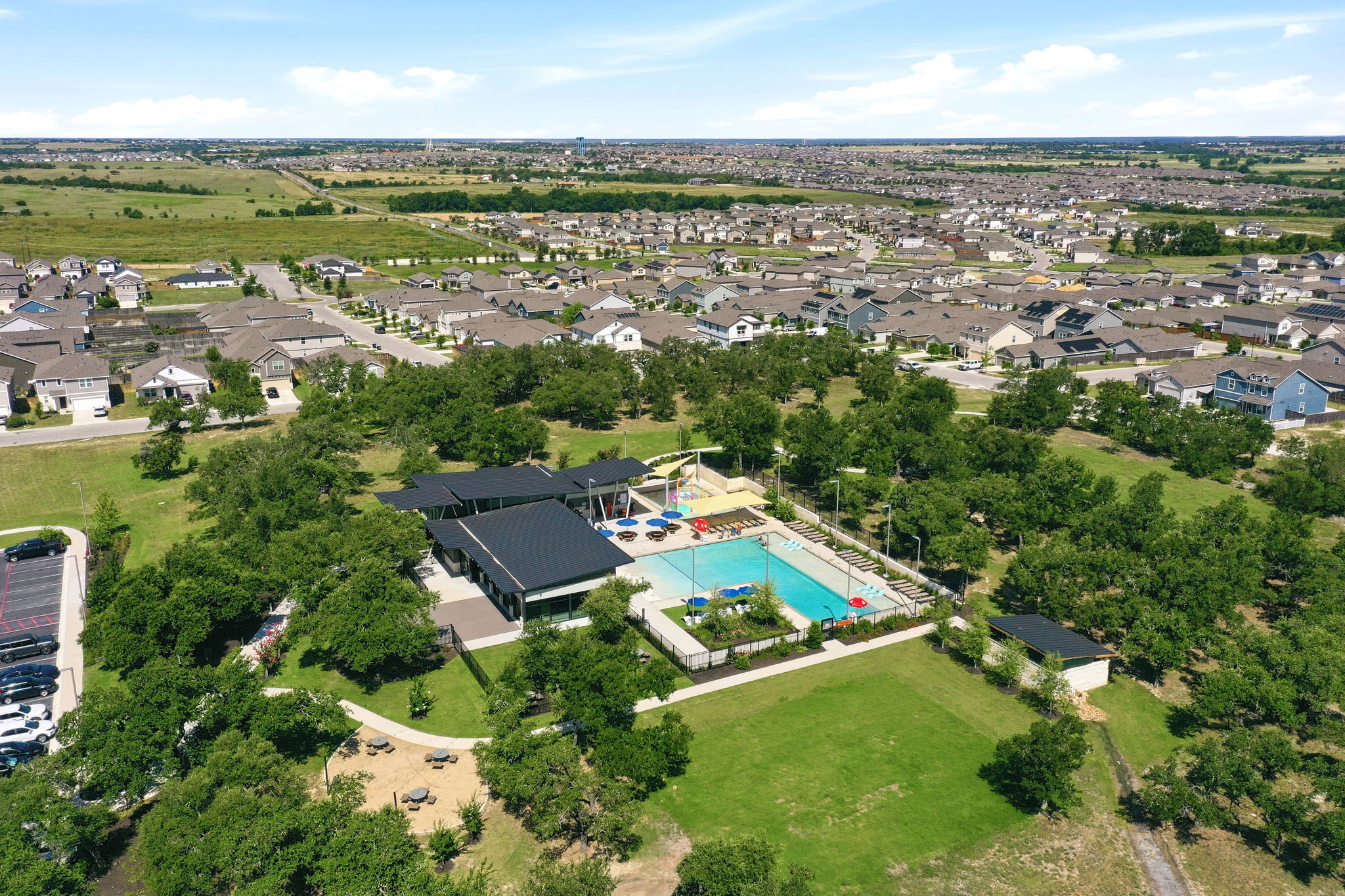 220 Lucky Texan Road Jarrell, TX 76537 - Photo 15 of 19 An aerial perspective reveals a vibrant community with a refreshing pool area and lush green spaces.