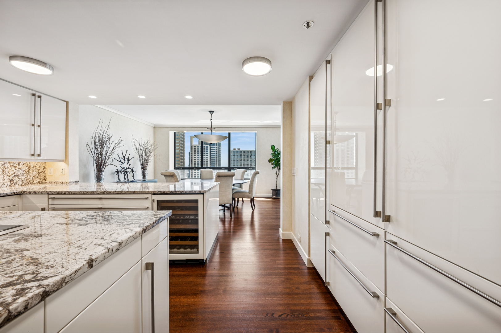 180 East Pearson Street, Unit 3701 Chicago, IL 60611 - Photo 13 of 36 a view of a kitchen with kitchen island granite countertop wooden floor and a refrigerator