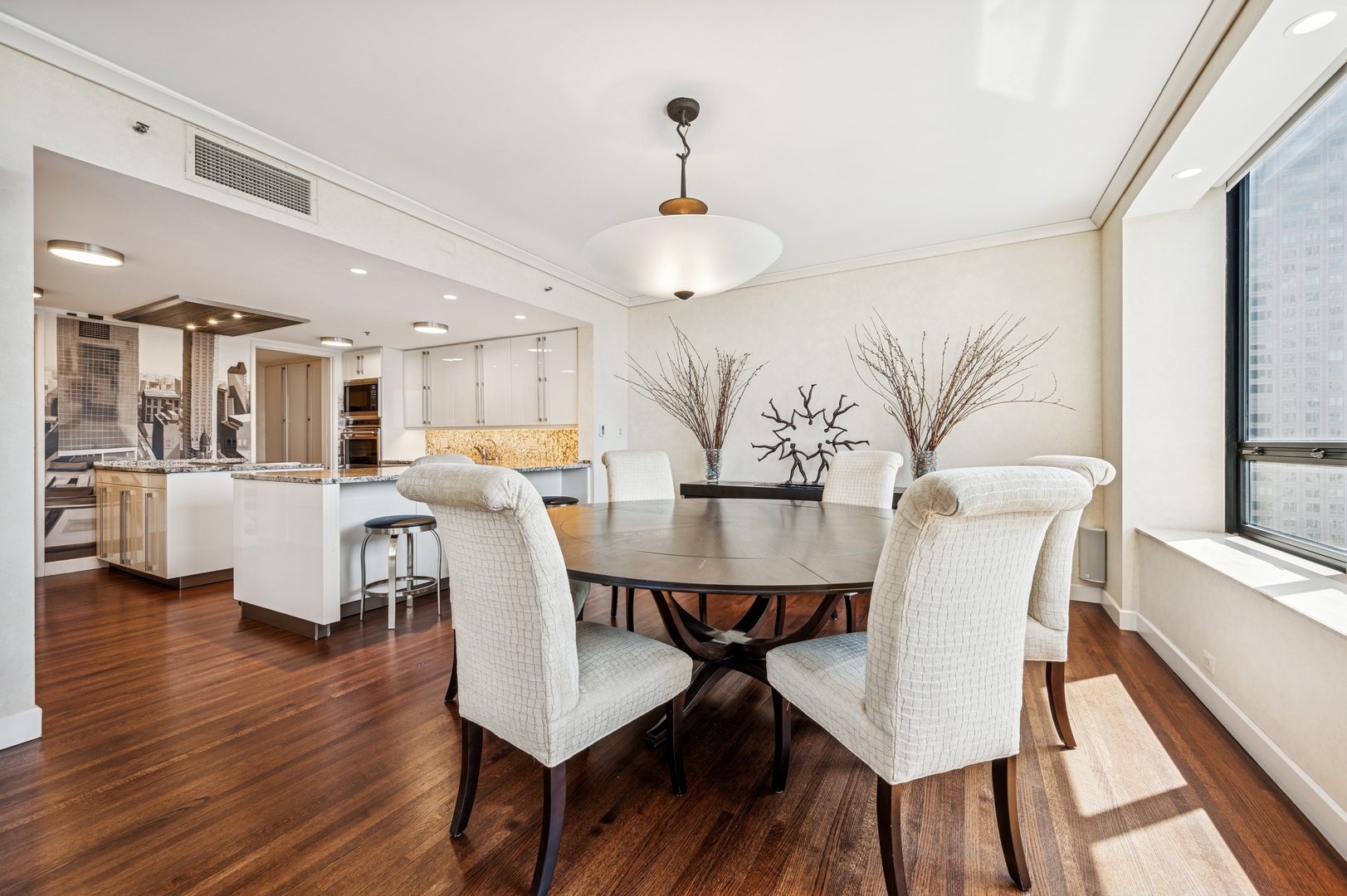 180 East Pearson Street, Unit 3701 Chicago, IL 60611 - Photo 14 of 36 a view of a dining room with furniture and wooden floor