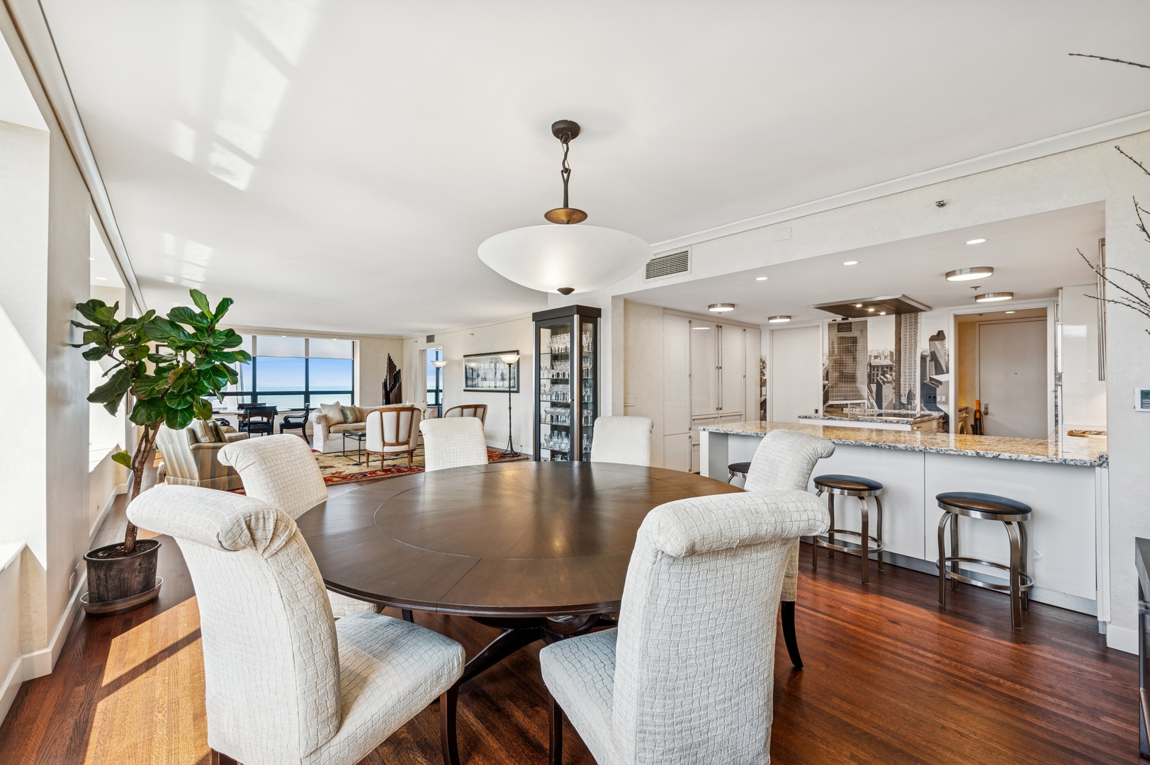 180 East Pearson Street, Unit 3701 Chicago, IL 60611 - Photo 15 of 36 a dining room with furniture a chandelier and wooden floor