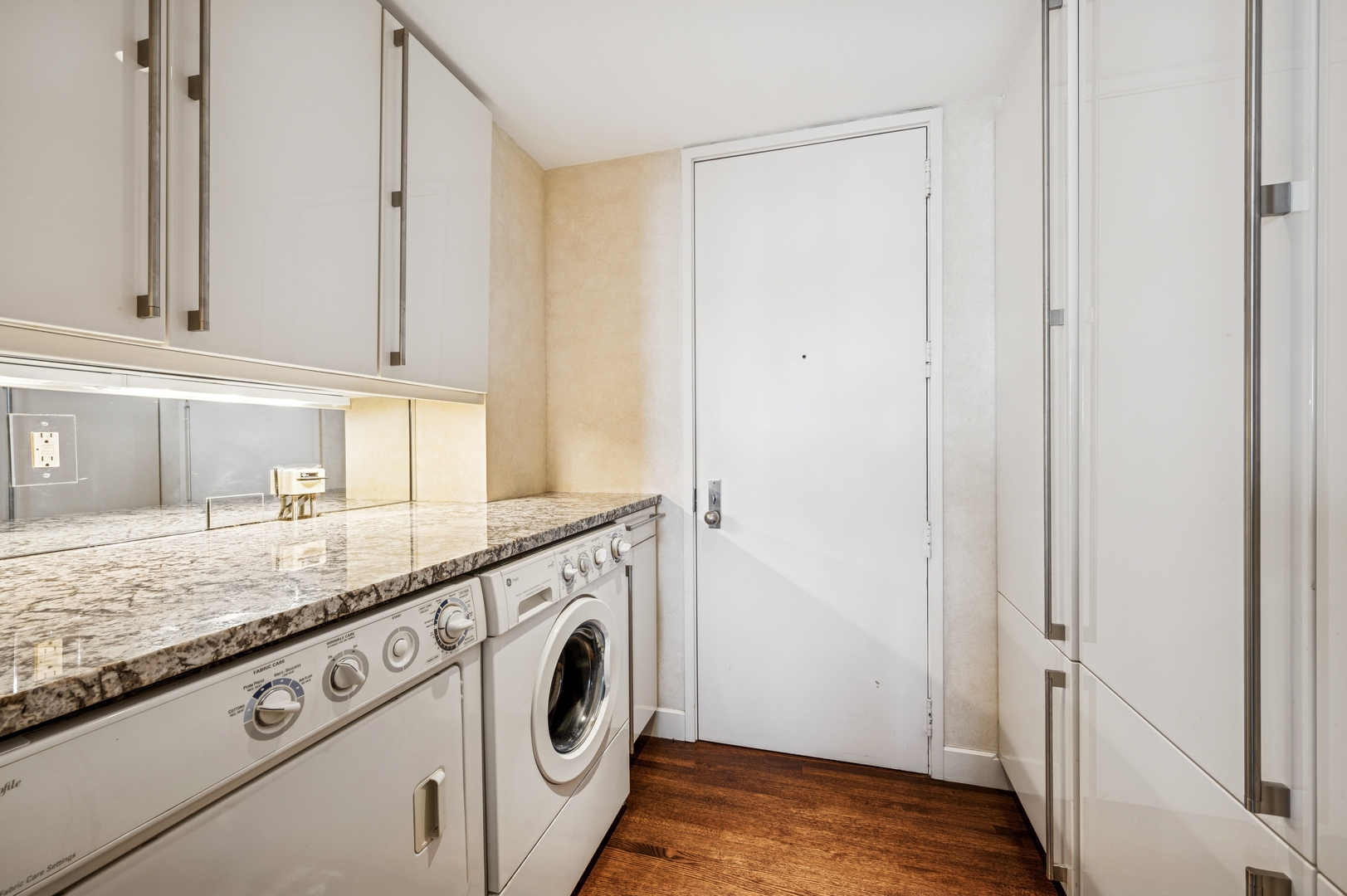 180 East Pearson Street, Unit 3701 Chicago, IL 60611 - Photo 25 of 36 a kitchen with granite countertop white cabinets and white appliances