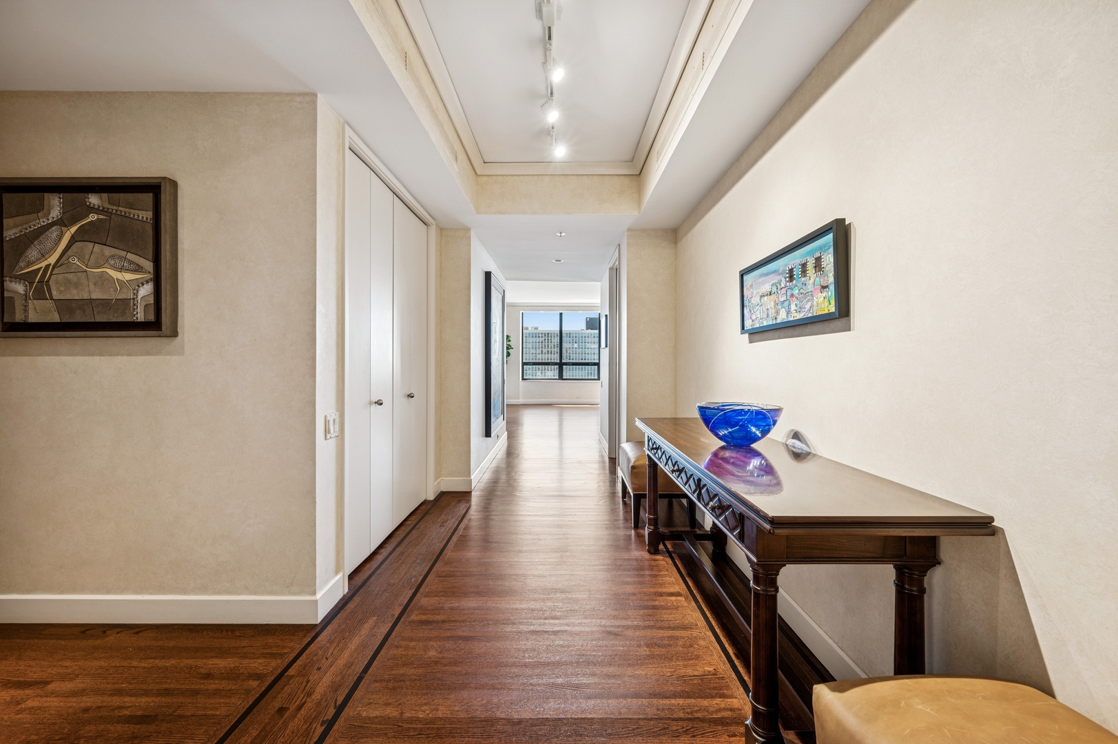 180 East Pearson Street, Unit 3701 Chicago, IL 60611 - Photo 5 of 36 a hallway with wooden floor stairs and furniture