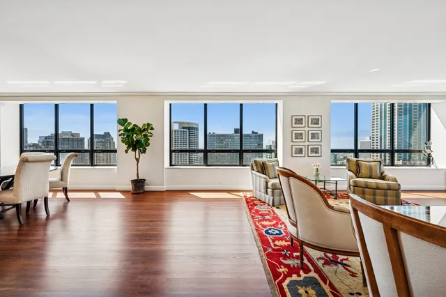 a kitchen with stainless steel appliances granite countertop a stove refrigerator and white cabinets with wooden floor