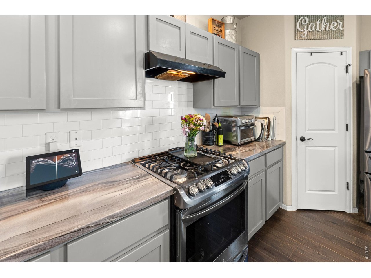 8847 16th St Road Greeley, CO 80634 - Photo 13 of 38 a kitchen with stainless steel appliances granite countertop a stove a refrigerator and a cabinets