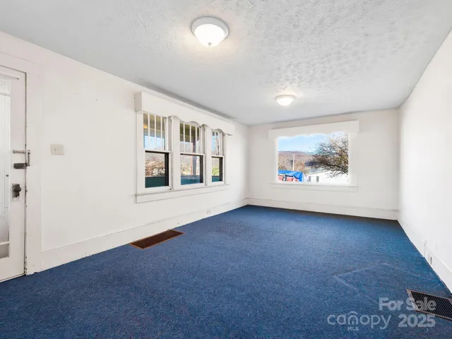 a kitchen with cabinets and refrigerator