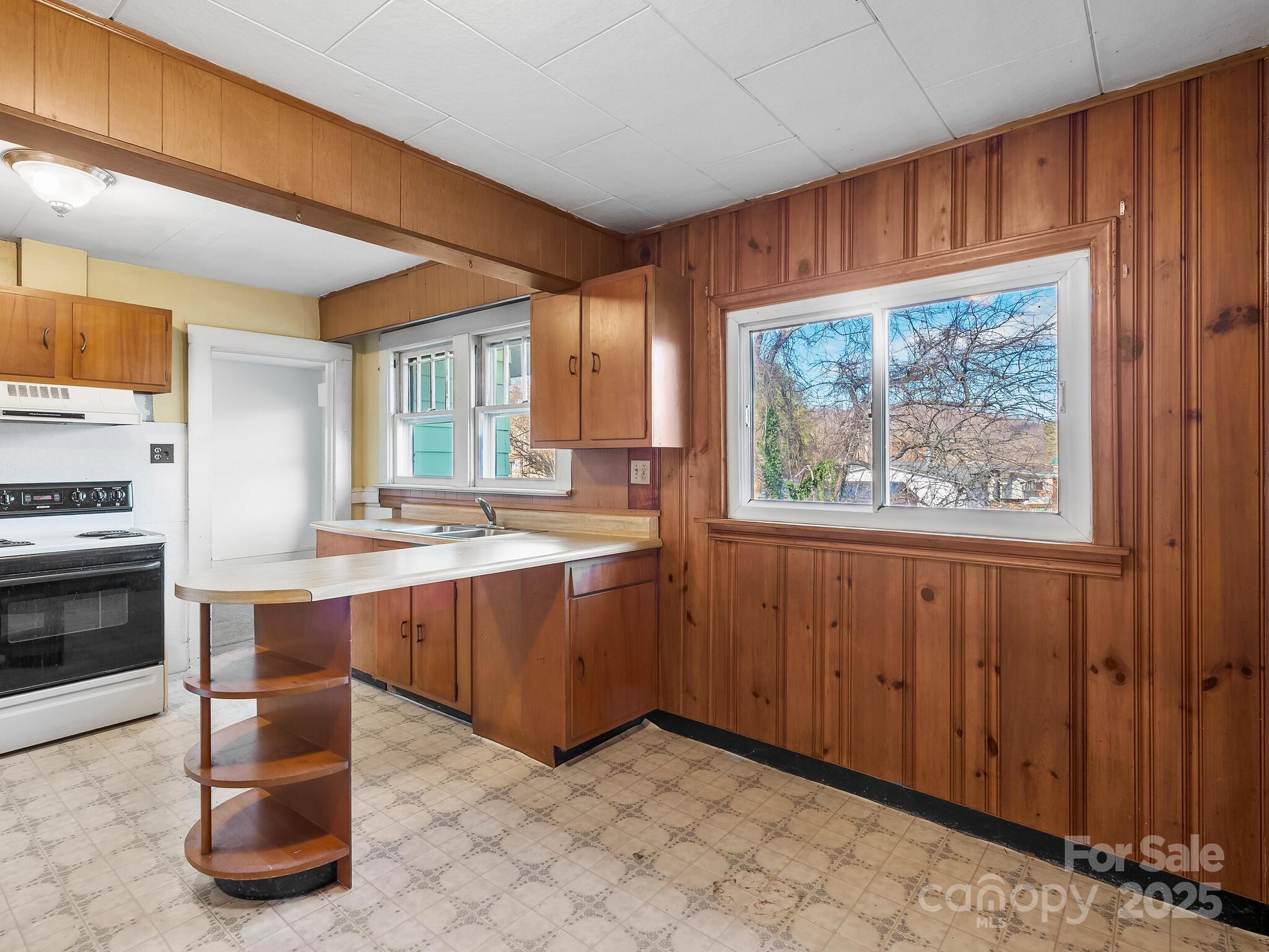 71 Lower Glady Fork Road Candler, NC 28715 - Photo 15 of 43 a kitchen with stainless steel appliances granite countertop a stove a sink and a refrigerator