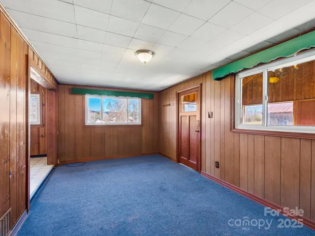 a view of wooden floor and windows in a room