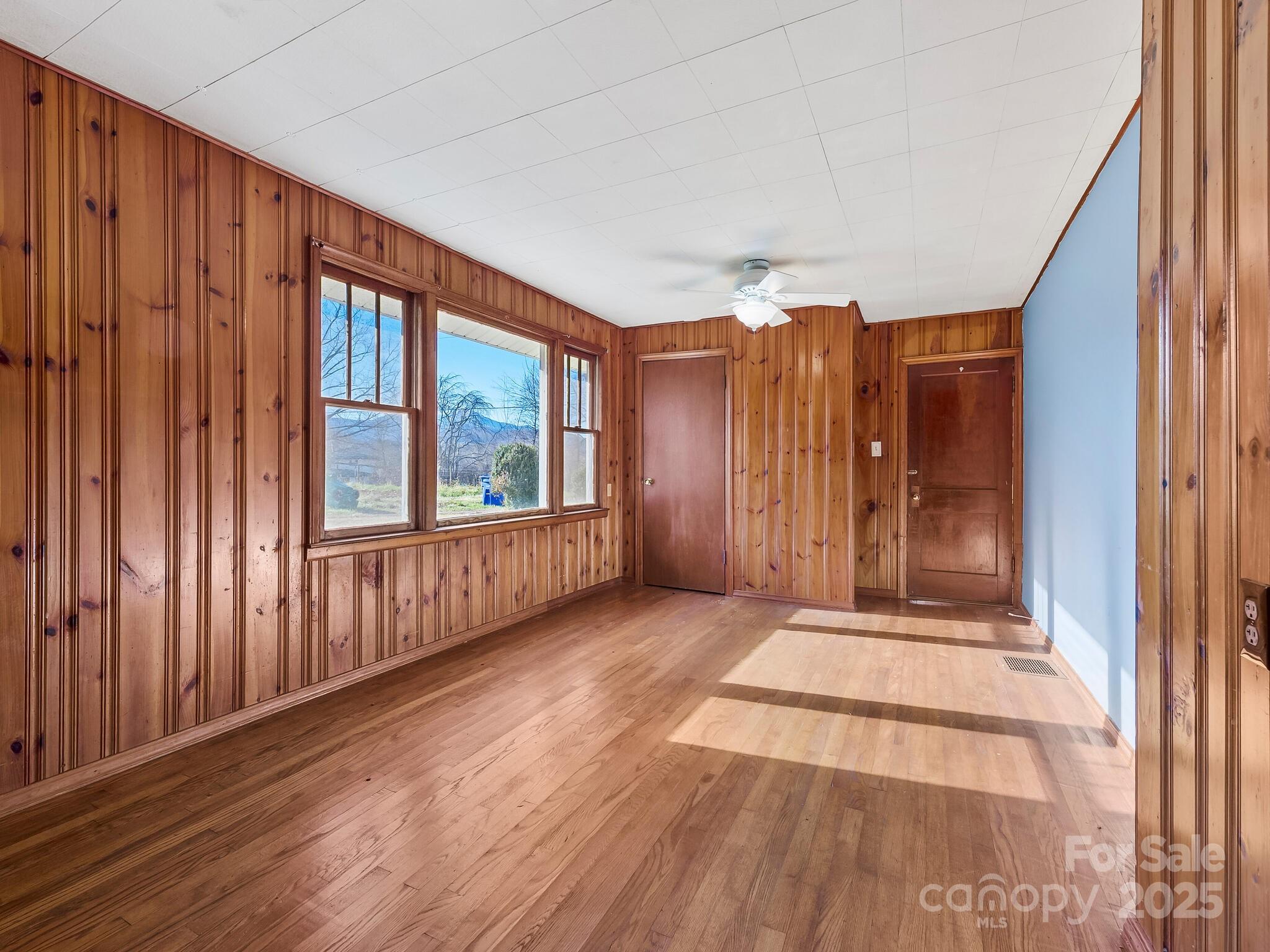 71 Lower Glady Fork Road Candler, NC 28715 - Photo 19 of 43 a view of wooden floor and windows in a room