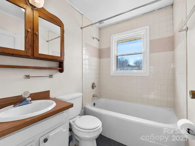 a view of a room with wooden floor and bench