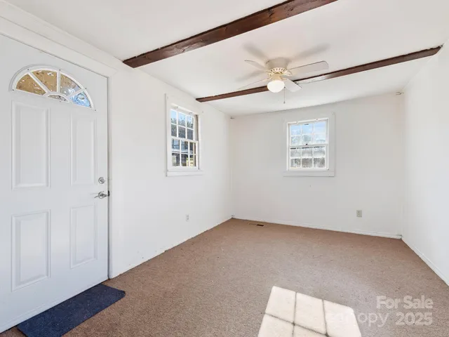 a view of an empty room with a fireplace