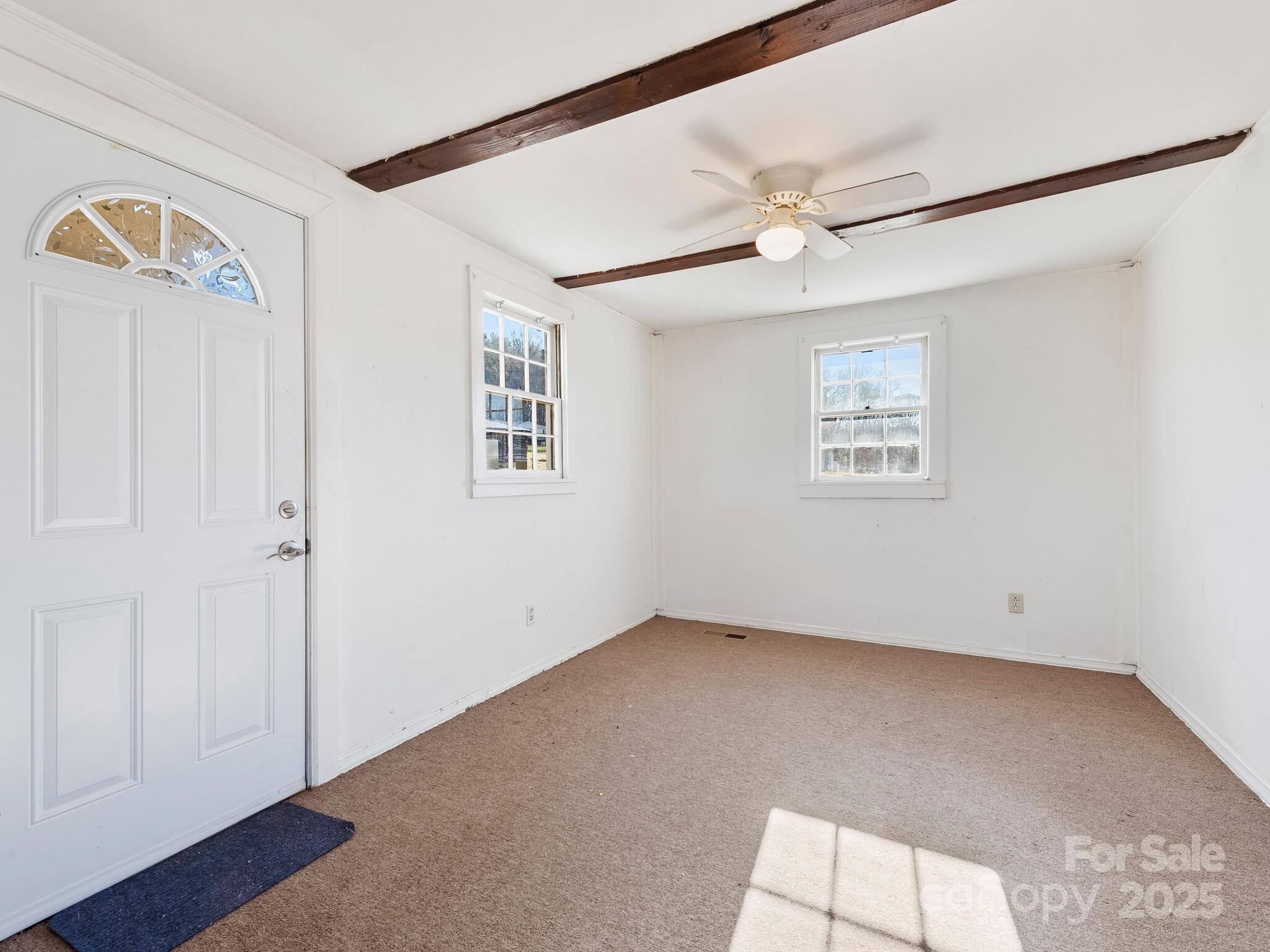 71 Lower Glady Fork Road Candler, NC 28715 - Photo 29 of 43 an empty room with windows and fan