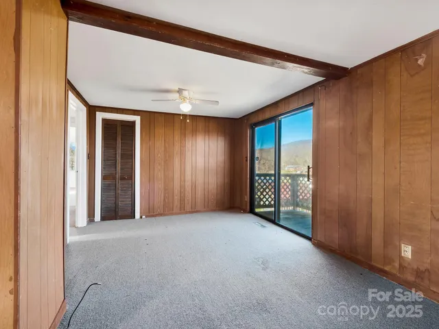 a view of a kitchen with stainless steel appliances granite countertop a sink and a stove next to a window