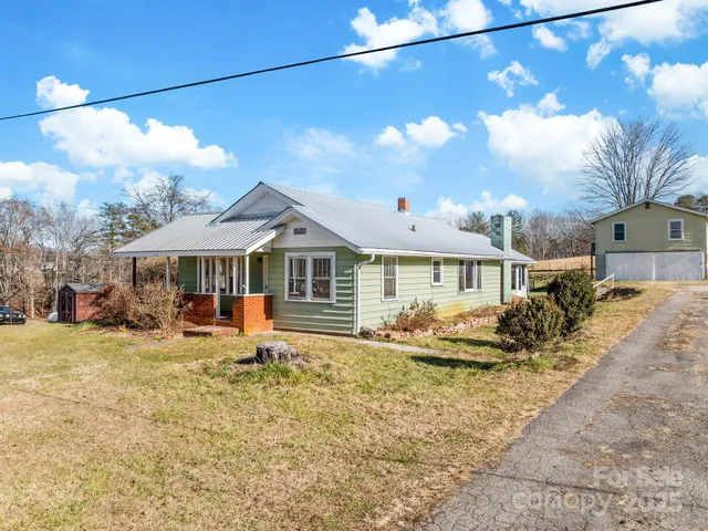 a front view of a house with yard porch and sitting area
