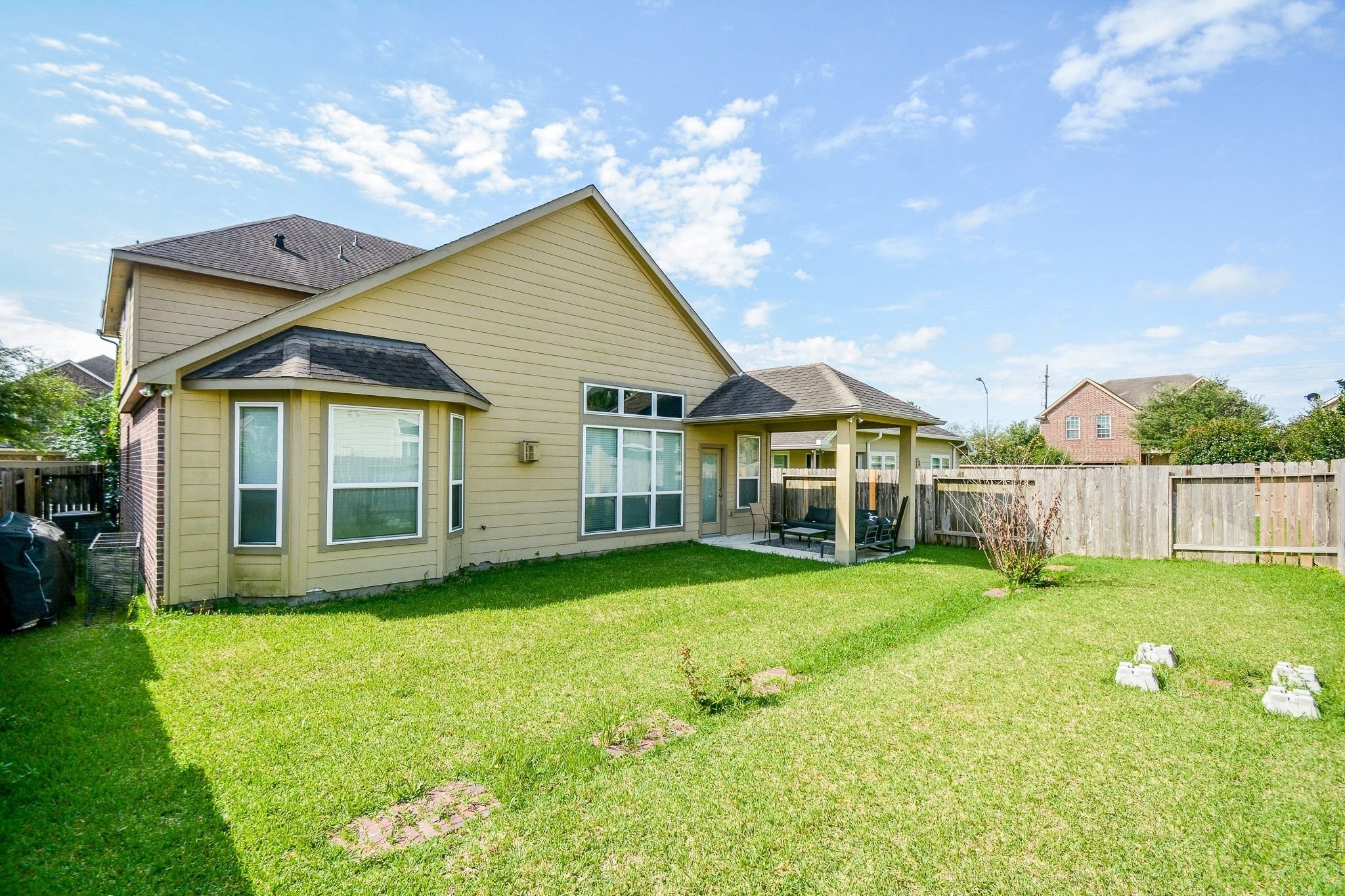 7046 Sliding Rock Circle Spring, TX 77379 - Photo 35 of 41 Experience outdoor living in this spacious, sunlit backyard, complete with a cozy patio perfect for relaxation and gatherings.