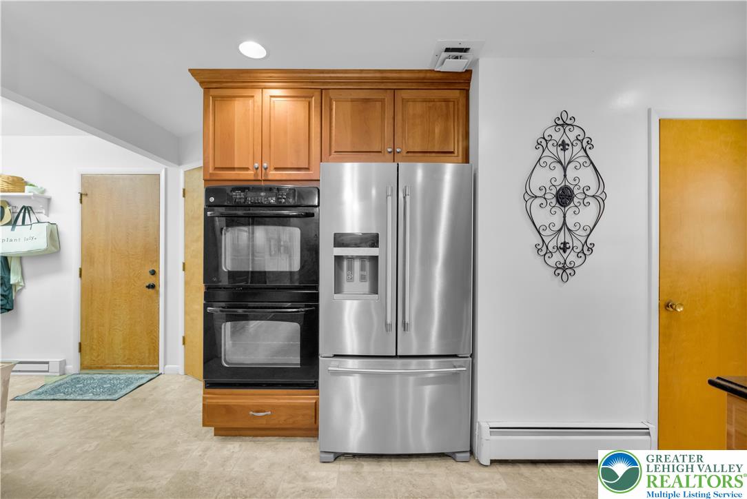 5747 Kernsville Road Orefield, PA 18069 - Photo 16 of 56 a kitchen with a refrigerator and a stove top oven
