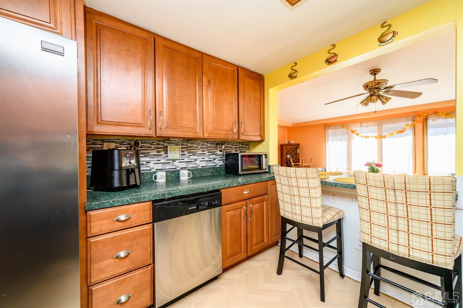 69 Bergerville Road Freehold, NJ 07728 - Photo 8 of 28 a kitchen with stainless steel appliances granite countertop a stove and cabinets