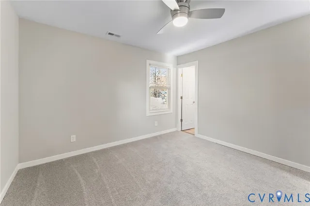 an empty room with a empty space and a ceiling fan