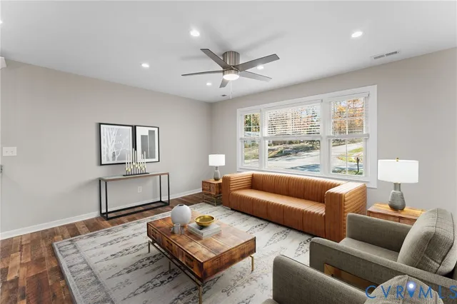 a living room with furniture a rug and a window