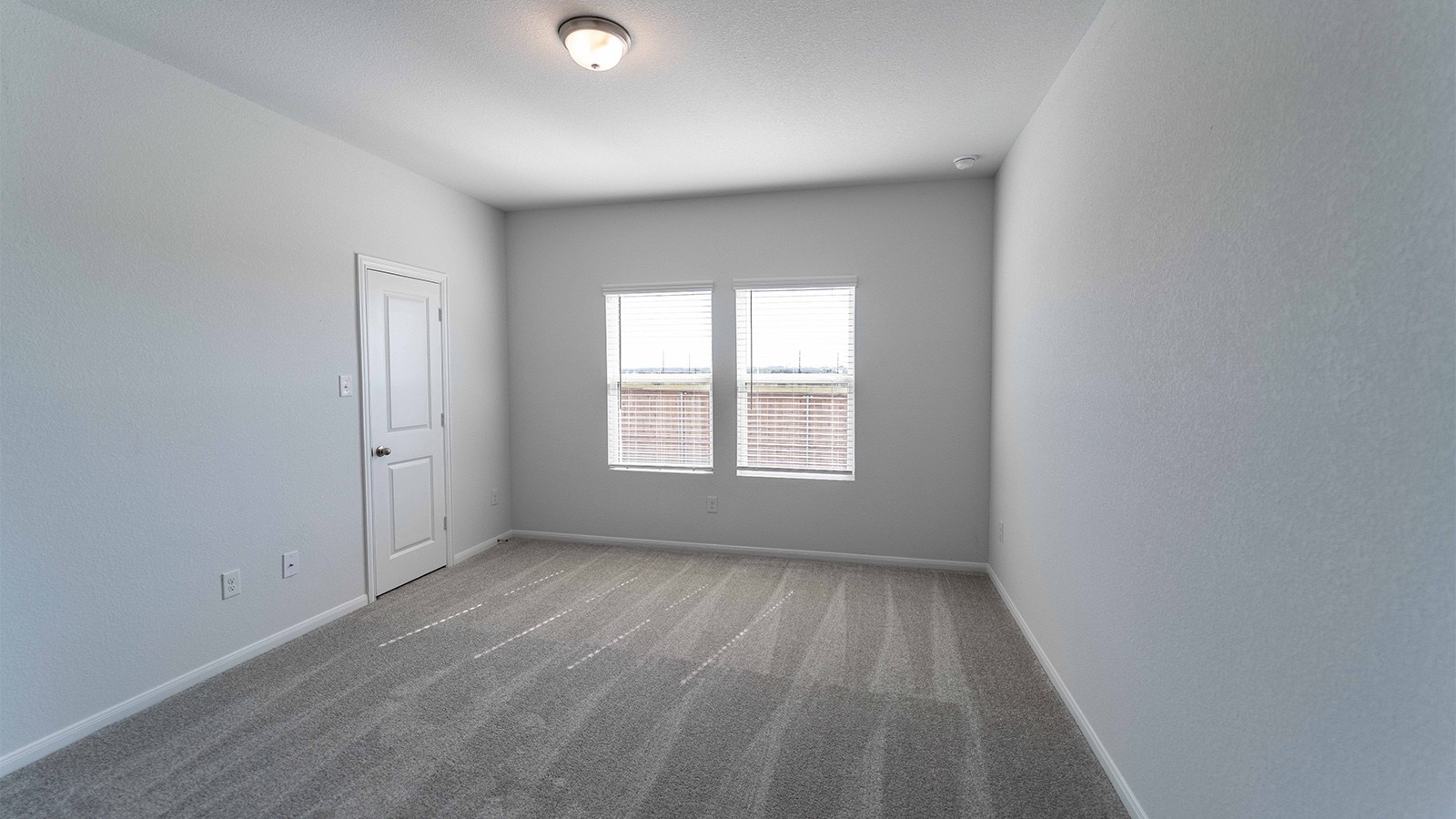 13605 Endless Narrow Lane Elgin, TX 78621 - Photo 3 of 16 an empty room with wooden floor and windows