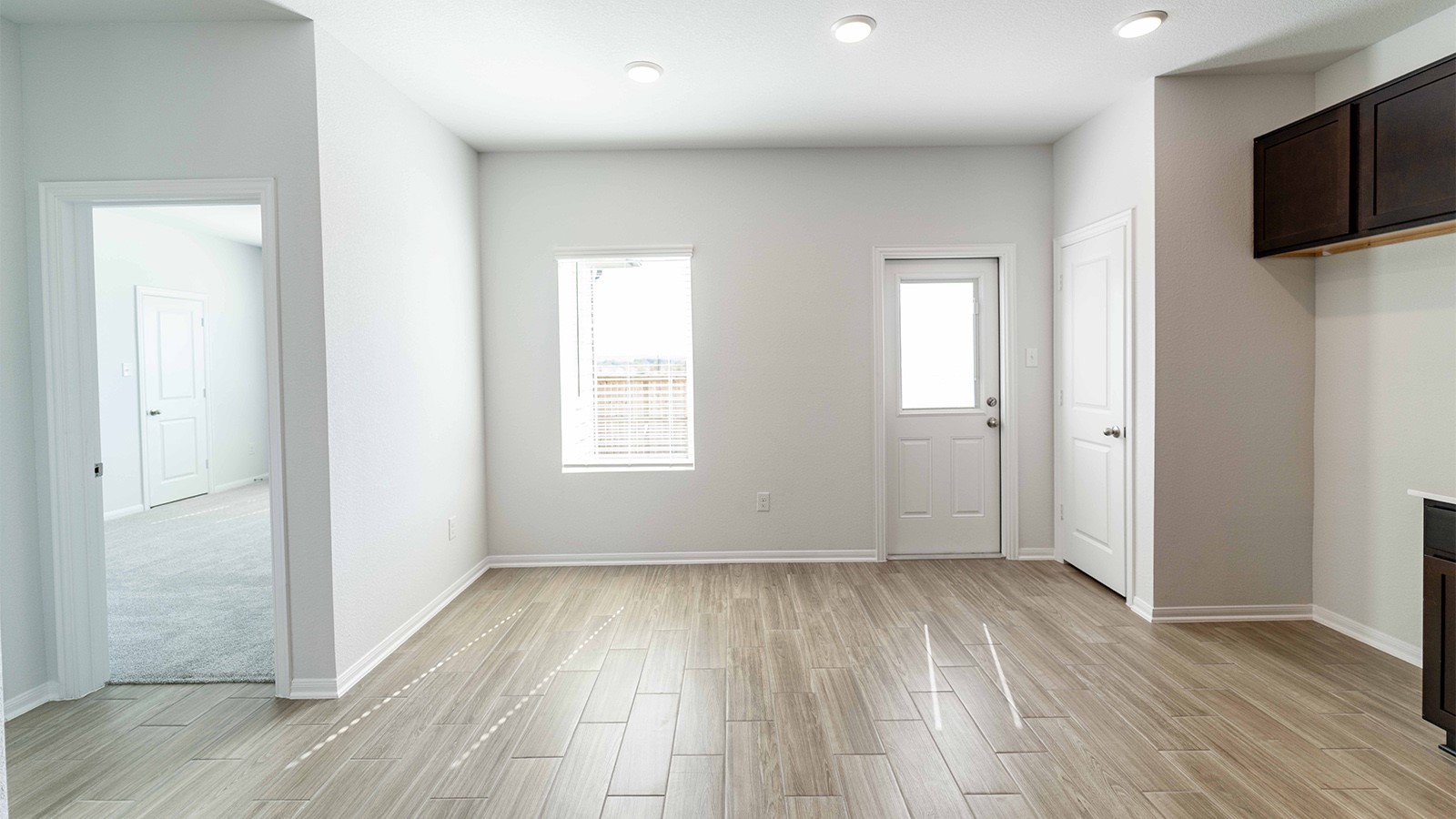 13605 Endless Narrow Lane Elgin, TX 78621 - Photo 6 of 16 an empty room with wooden floor and windows