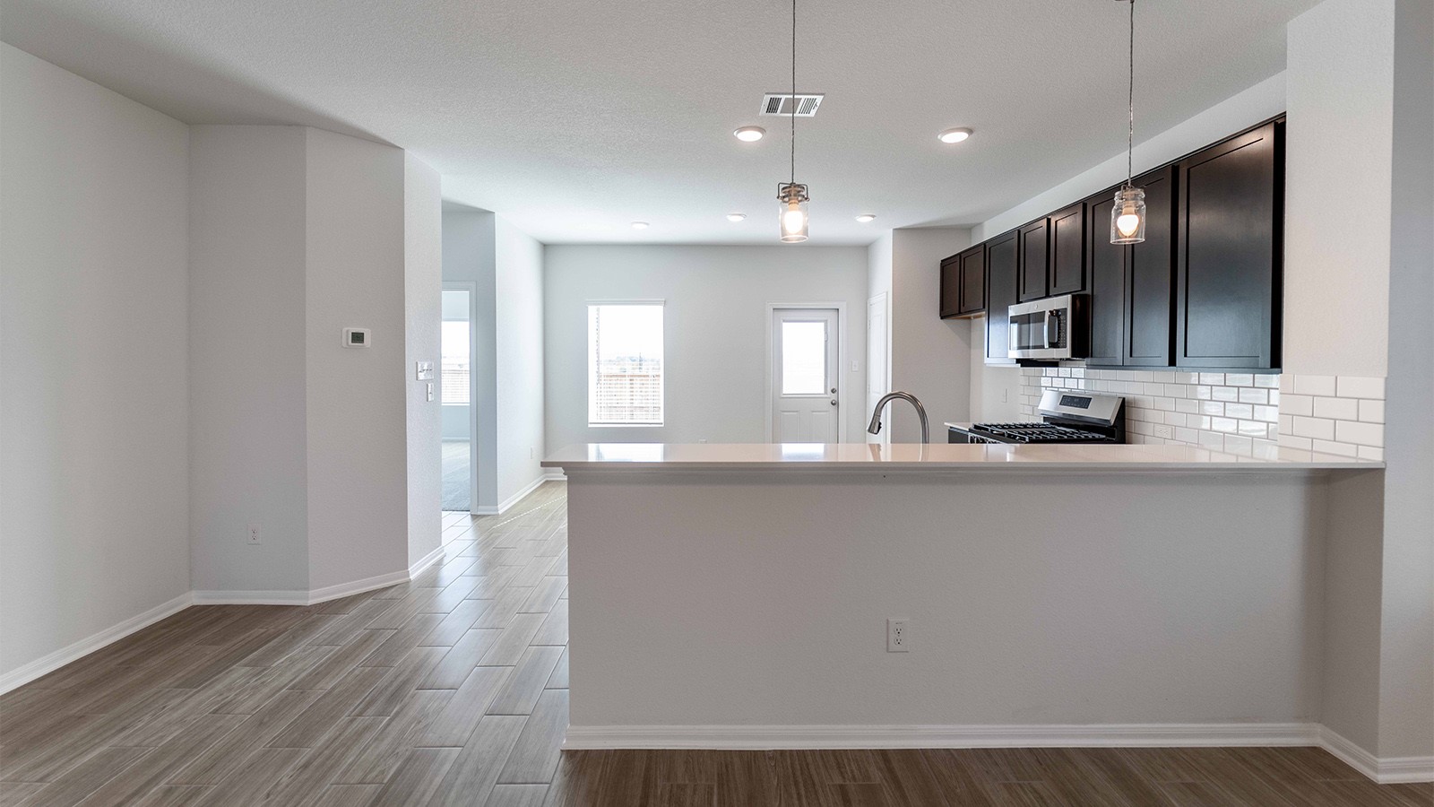 13605 Endless Narrow Lane Elgin, TX 78621 - Photo 7 of 16 a view of a kitchen with a sink and a large mirror
