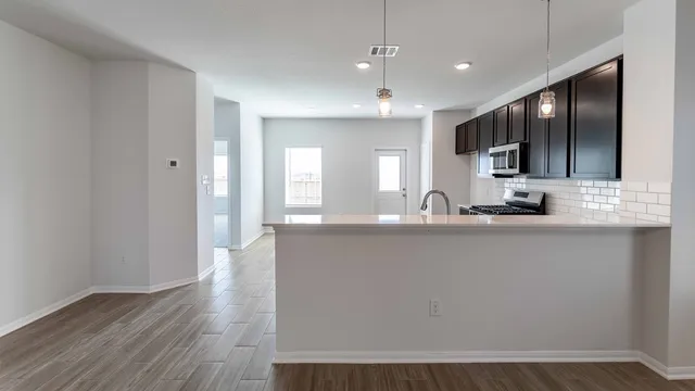 a view of a kitchen with a sink and a refrigerator