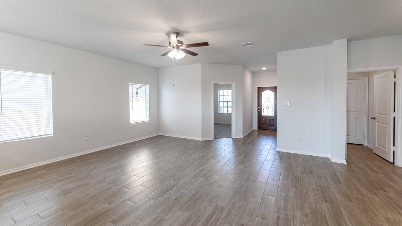 13605 Endless Narrow Lane Elgin, TX 78621 - Photo 8 of 16 a view of an empty room with wooden floor and window