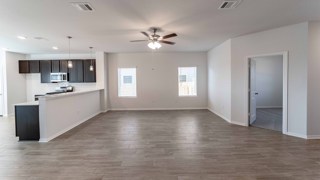13605 Endless Narrow Lane Elgin, TX 78621 - Photo 10 of 16 a view of an empty room with window and wooden floor