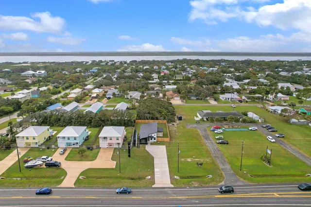 an aerial view of residential houses with outdoor space
