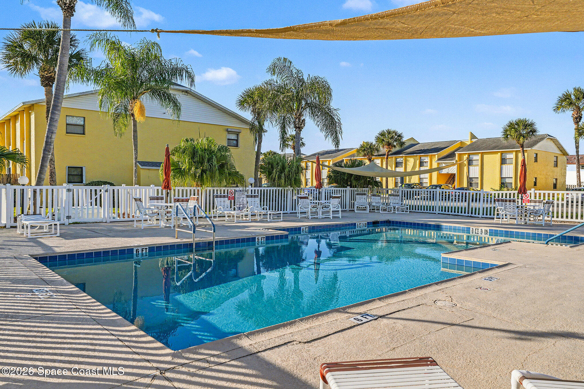 598 North Wickham Road, Unit 74 Melbourne, FL 32935 - Photo 12 of 13 a view of swimming pool with outdoor seating and a garden