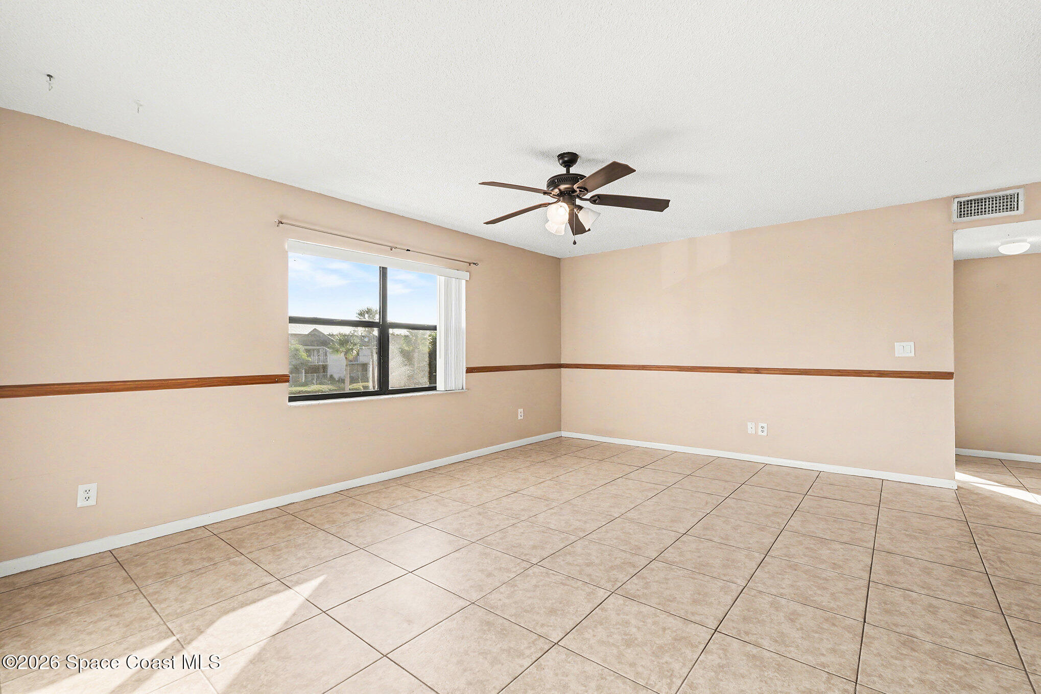598 North Wickham Road, Unit 74 Melbourne, FL 32935 - Photo 5 of 13 a view of an empty room with a window