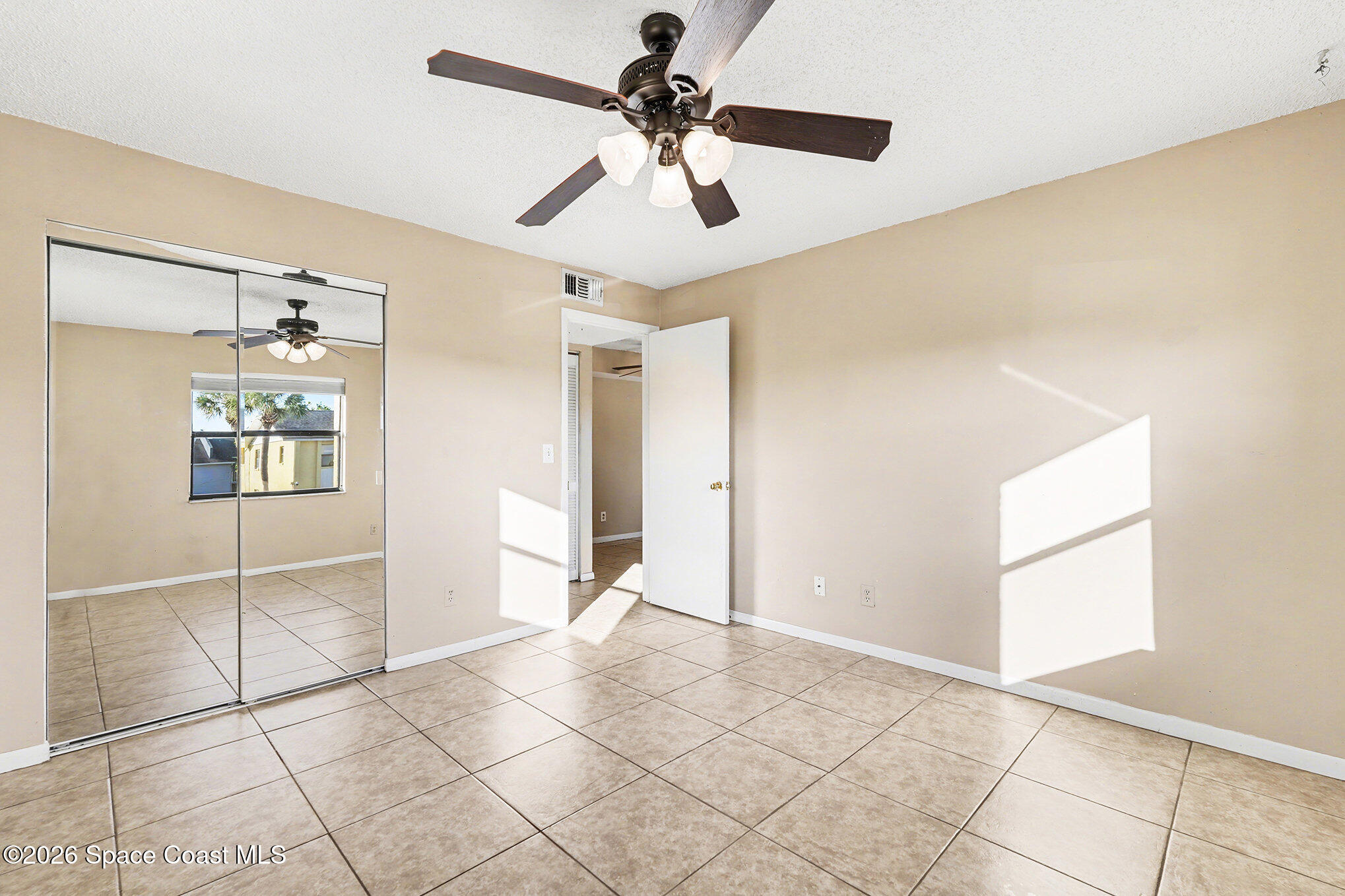 598 North Wickham Road, Unit 74 Melbourne, FL 32935 - Photo 10 of 13 a view of an empty room with a window