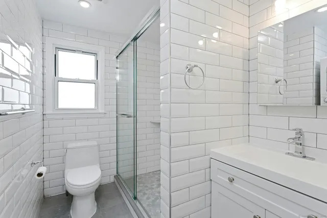 a bathroom with a toilet sink and shower