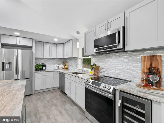 a kitchen with a sink stove and microwave