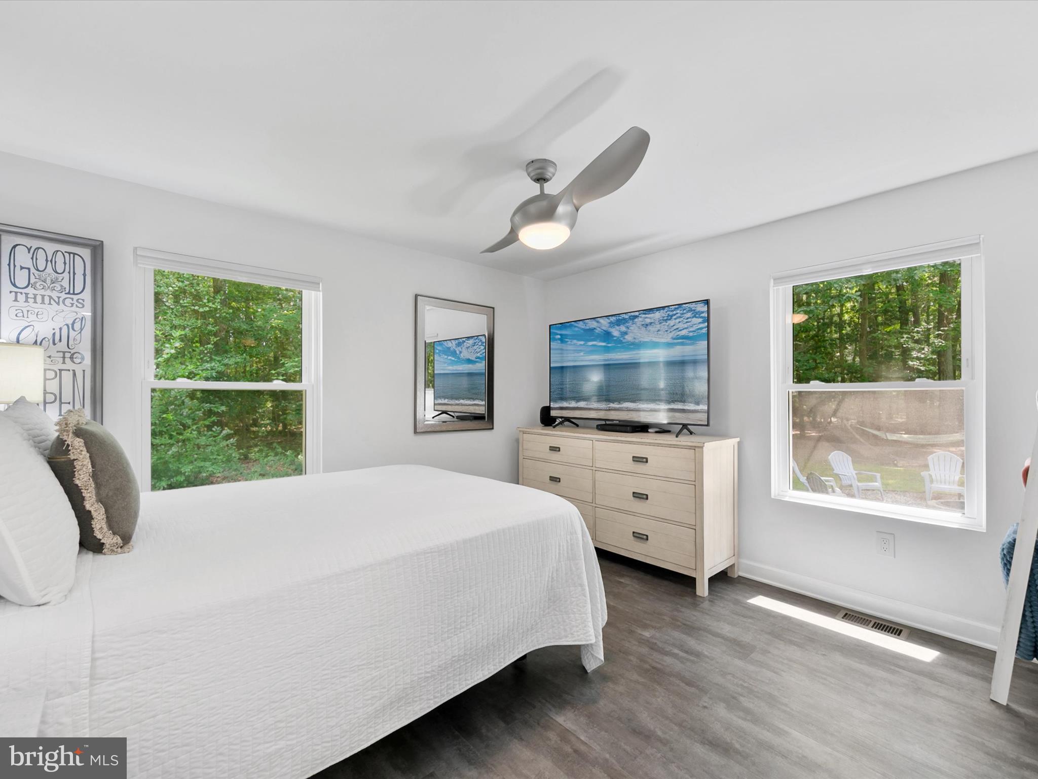 26076 Anderson Corner Road Georgetown, DE 19947 - Photo 14 of 36 a bedroom with a large bed and a flat tv screen on dresser