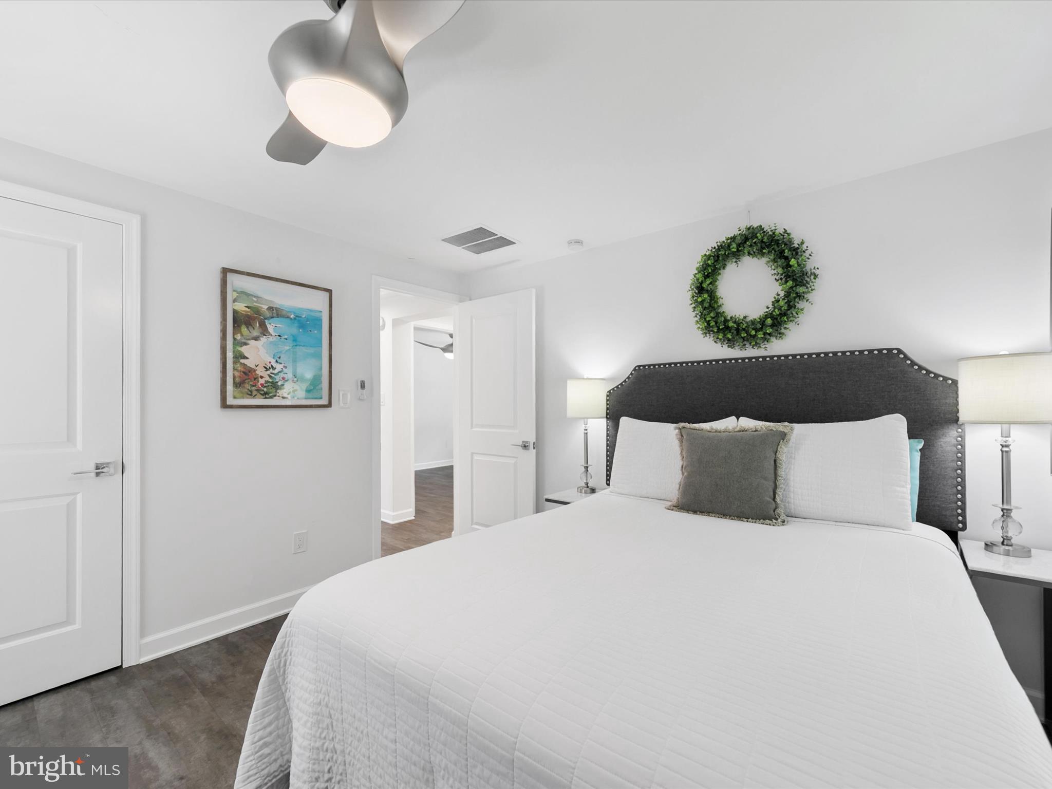 26076 Anderson Corner Road Georgetown, DE 19947 - Photo 16 of 36 a bedroom with a bed and painting on the wall