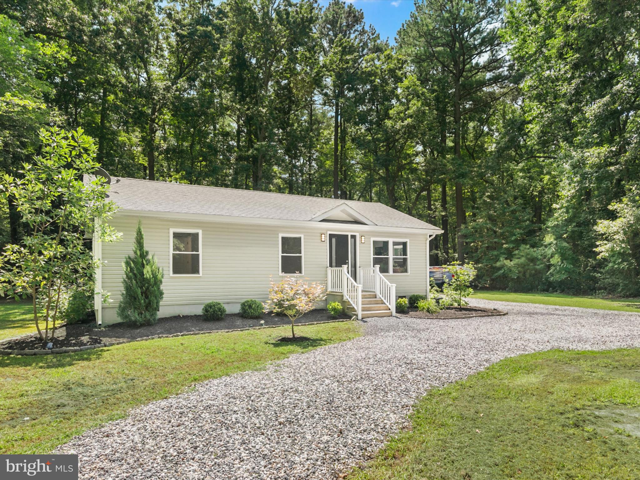 26076 Anderson Corner Road Georgetown, DE 19947 - Photo 2 of 36 a front view of a house with garden