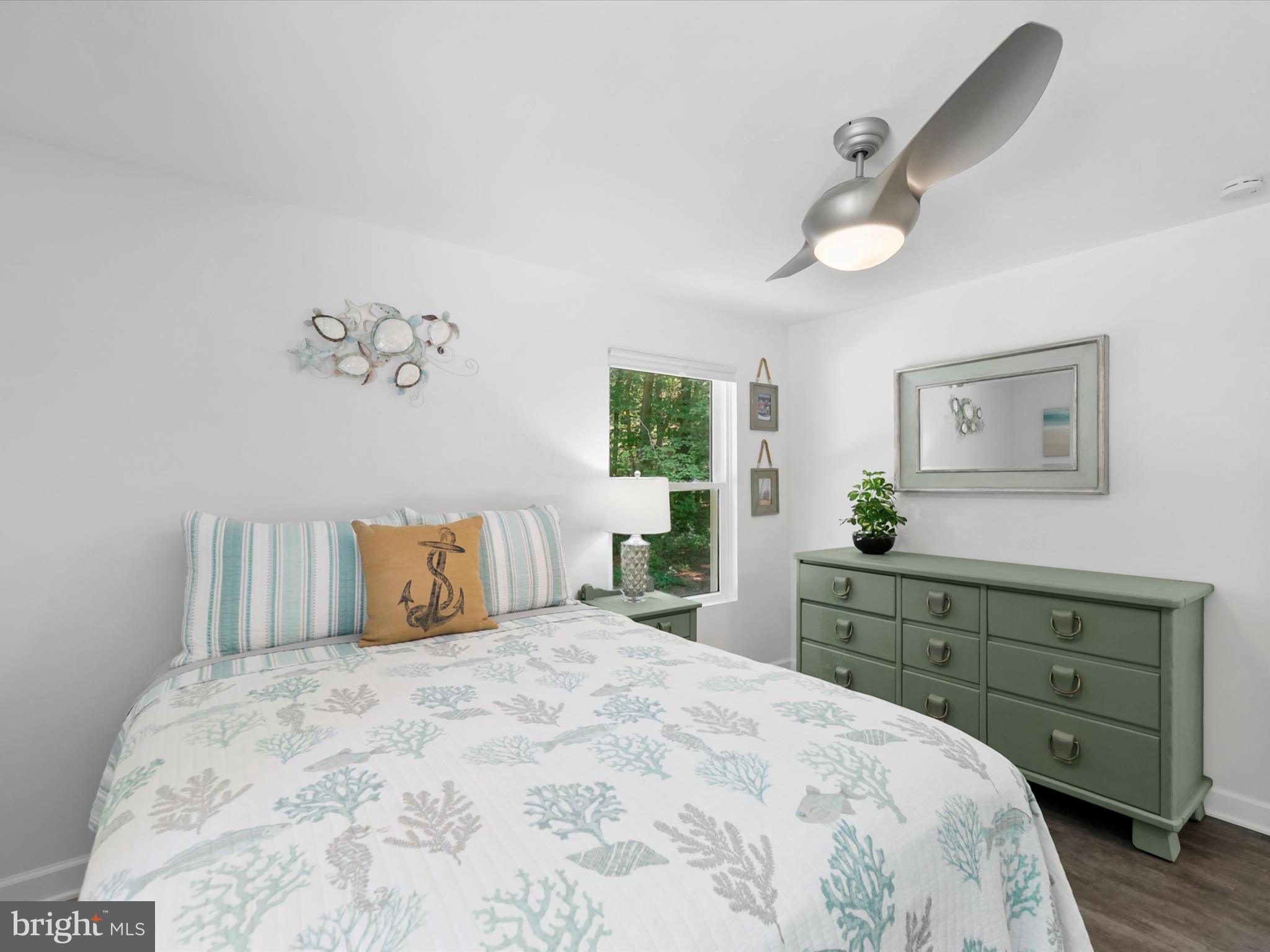 26076 Anderson Corner Road Georgetown, DE 19947 - Photo 21 of 36 a bedroom with a large bed and a dresser