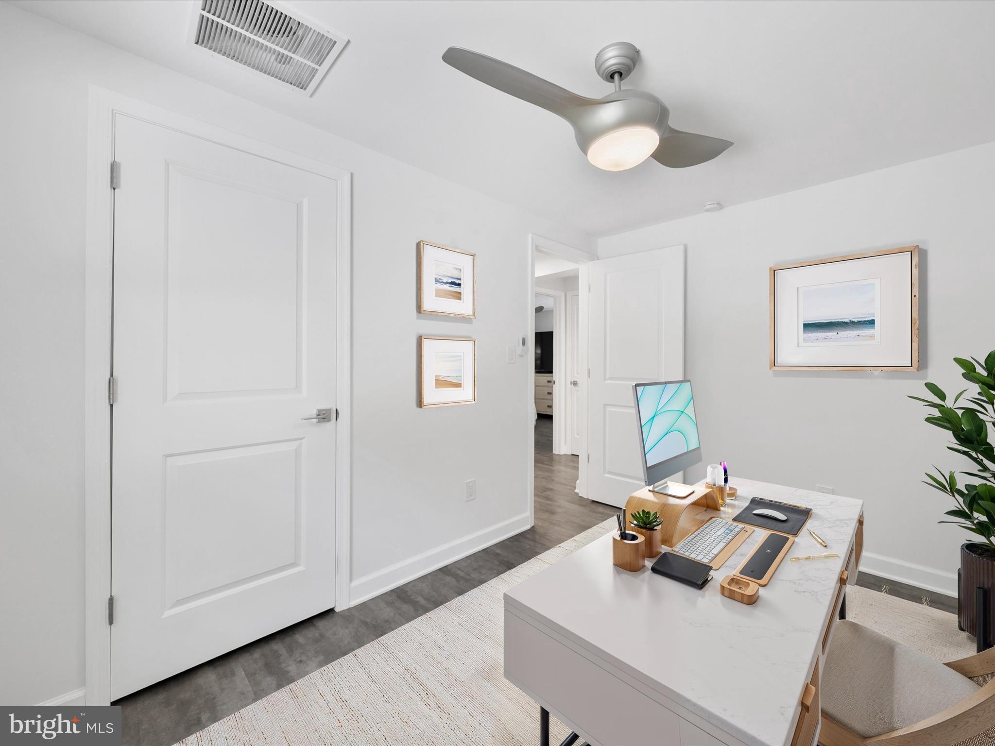 26076 Anderson Corner Road Georgetown, DE 19947 - Photo 23 of 36 a view of a workspace with furniture and wooden floor