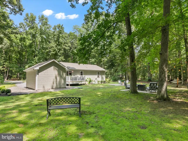 a view of a house with a yard porch and sitting area
