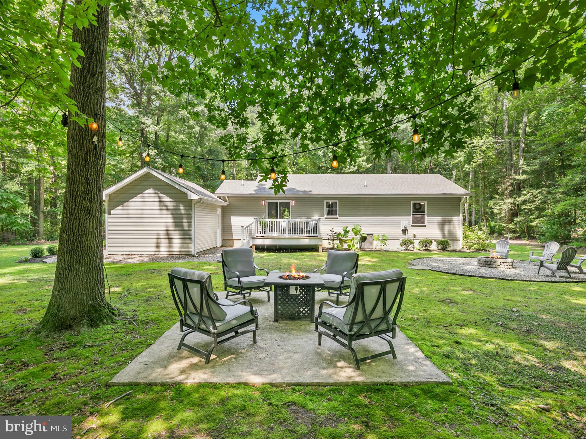 26076 Anderson Corner Road Georgetown, DE 19947 - Photo 31 of 36 a view of a house with backyard sitting area and garden