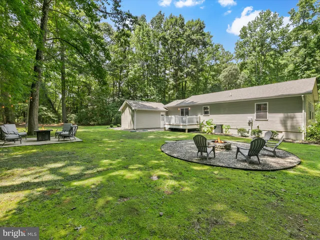 a front view of house with a garden and patio