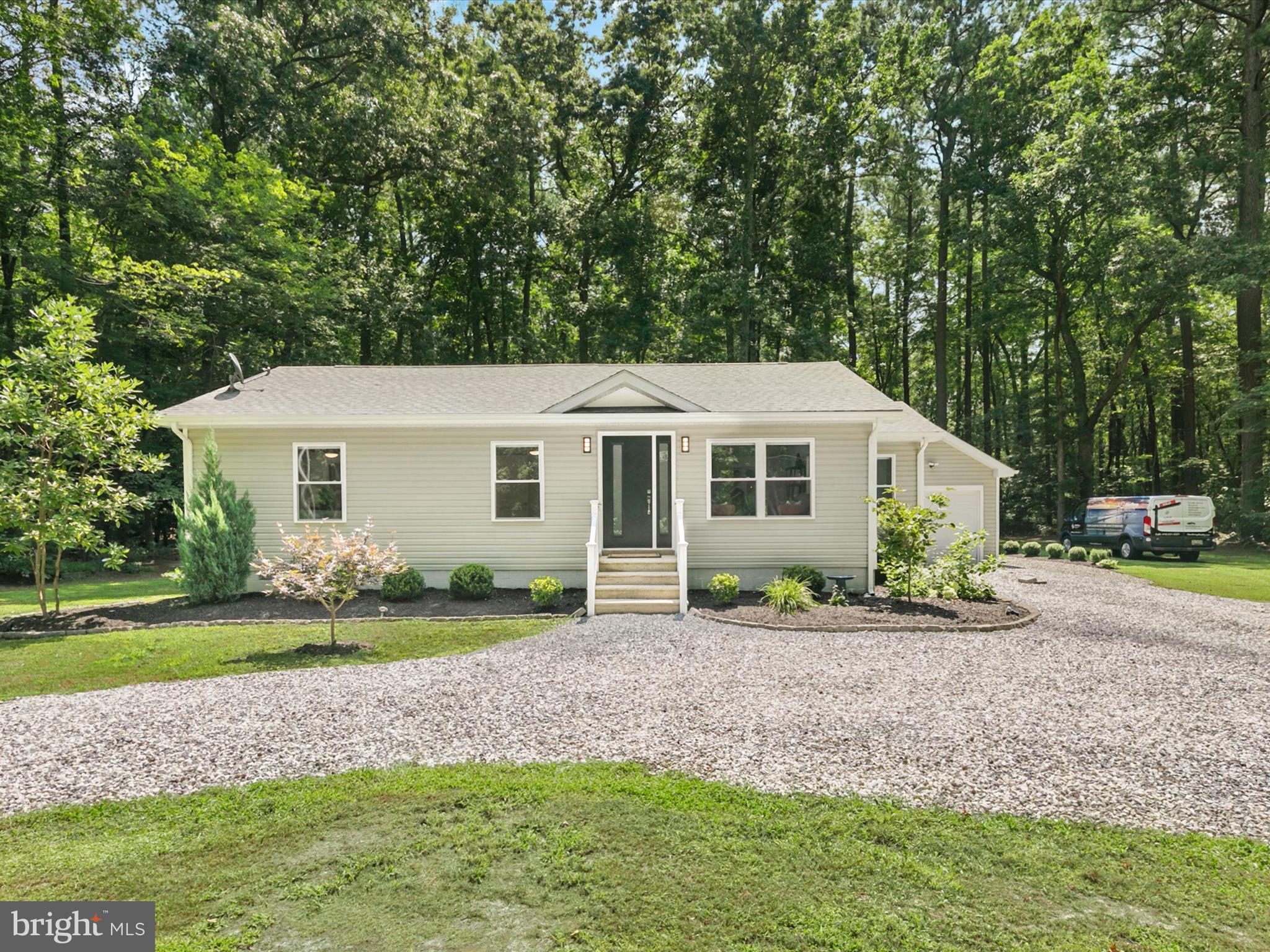 26076 Anderson Corner Road Georgetown, DE 19947 - Photo 34 of 36 a front view of a house with a yard and porch