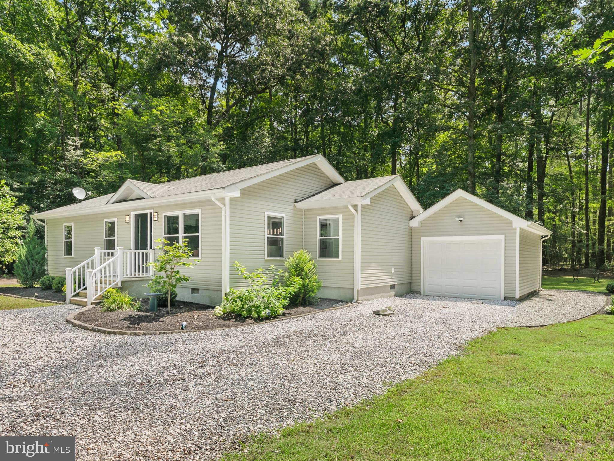 26076 Anderson Corner Road Georgetown, DE 19947 - Photo 35 of 36 a view of a white house with a yard and large trees
