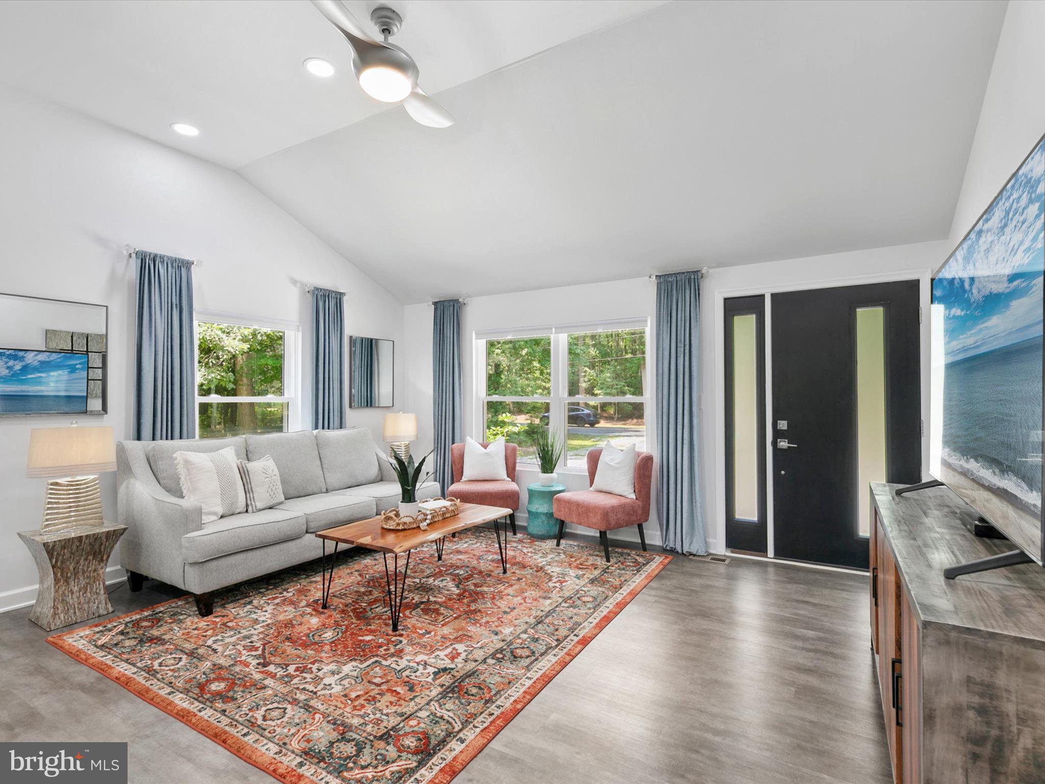26076 Anderson Corner Road Georgetown, DE 19947 - Photo 4 of 36 a living room with furniture large window and a rug