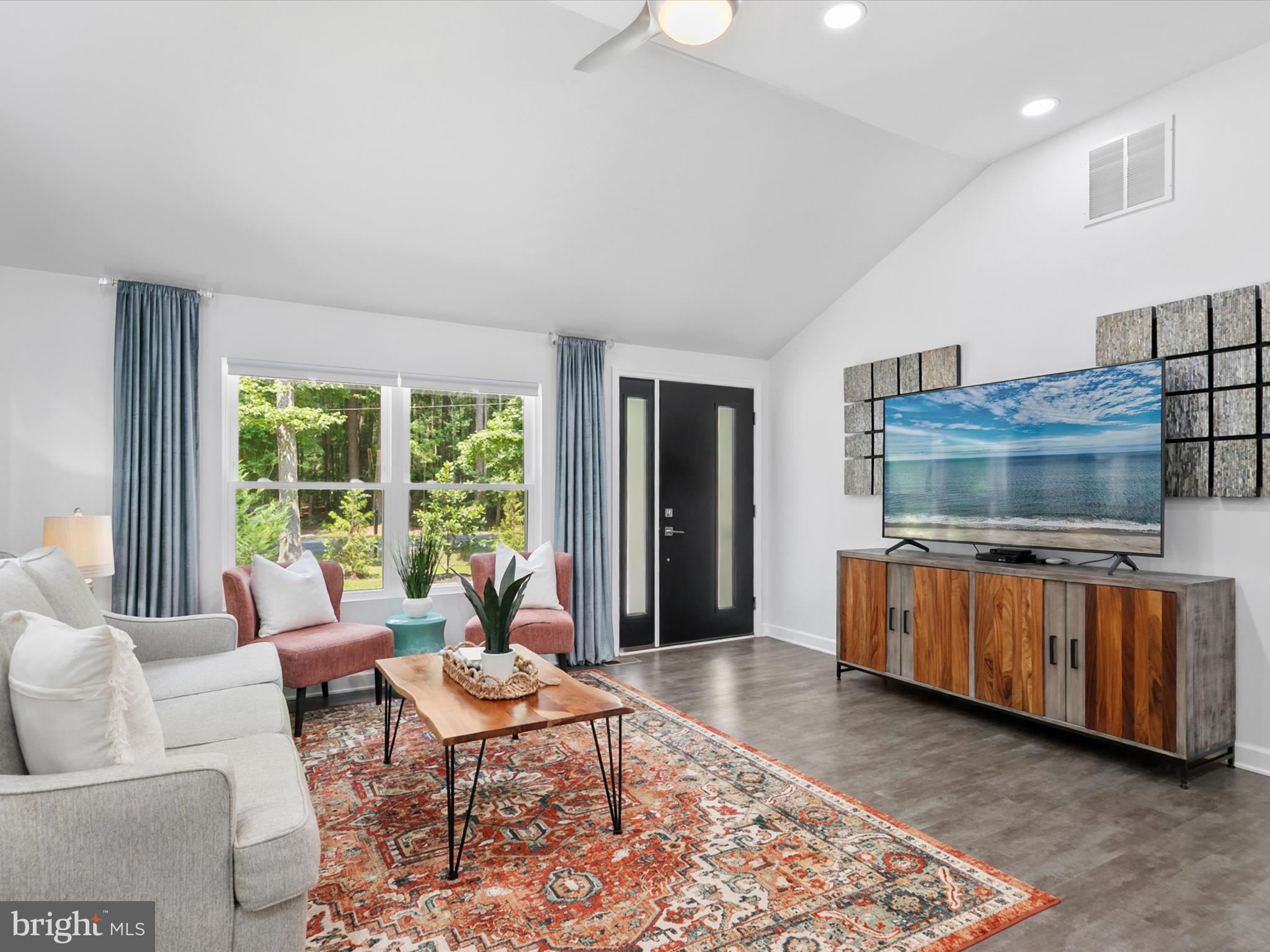 26076 Anderson Corner Road Georgetown, DE 19947 - Photo 5 of 36 a living room with furniture and a flat screen tv