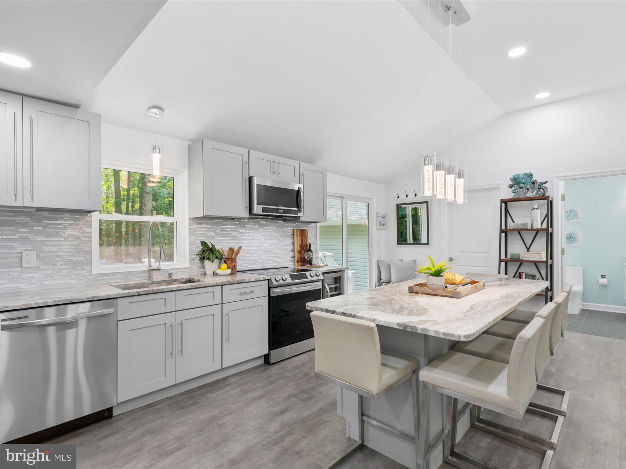 26076 Anderson Corner Road Georgetown, DE 19947 - Photo 9 of 36 a kitchen with appliances cabinets and dining table