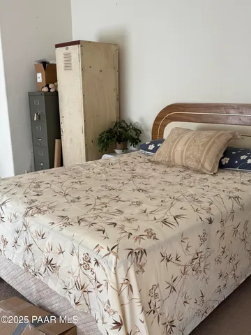 a bedroom with a bed and a mirror